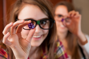 Girls Holding RPG Dice